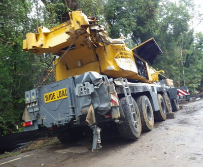 Export Logistics & Shipping, Inc. heavy machinery Liebherr LTM1250 crane gets stuck on road